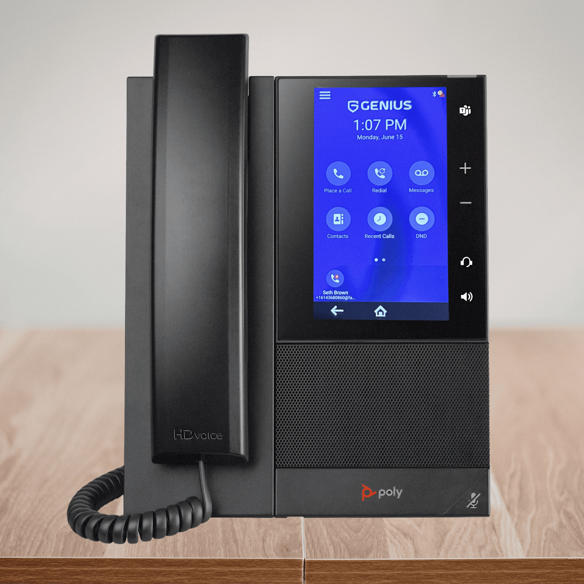 A Poly desk phone provisioned with GENIUS, on a desk